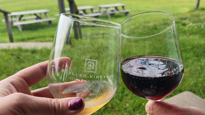 Couple holding wine glasses at Röbller Vineyard in New Haven, Missouri.