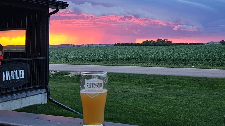 A beer with a sunset backdrop at Kinkaider Brewing Co. Broken Bow
