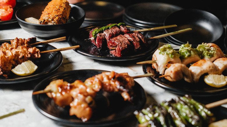 A variety of food served on skewers