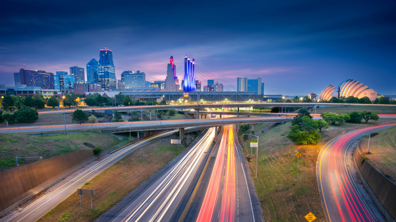 Kansas city skyline at dusk with roads in foreground