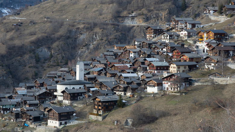 Wooden chalets and modern church steeple in village of Albinen, Switzerland