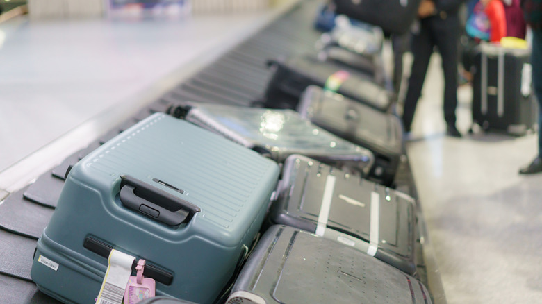 Assortment of luggage on an airport carousel for checked suitcases