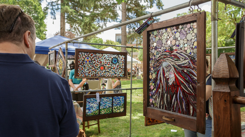 Outdoor art festival and vendor with stained glass on display