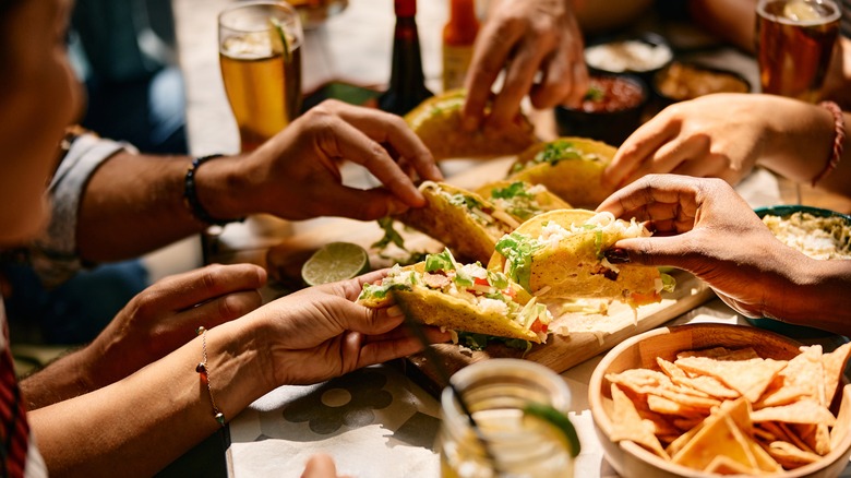 Diners eating Mexican food in restaurant