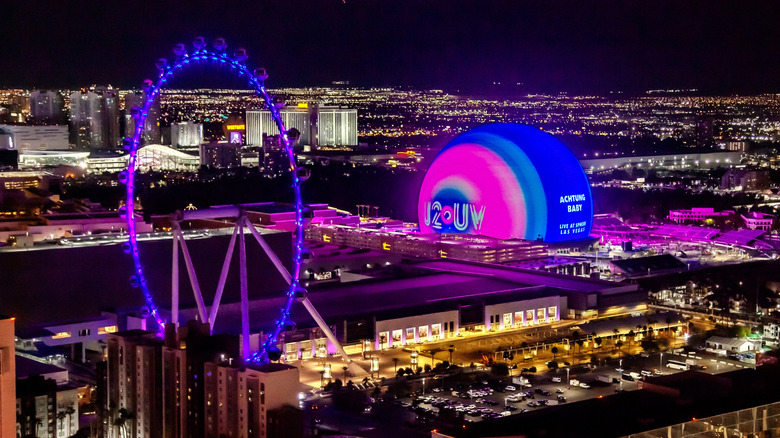 The Sphere in Las Vegas, Nevada is lit up with blue and violet against the city's nocturnal skyline
