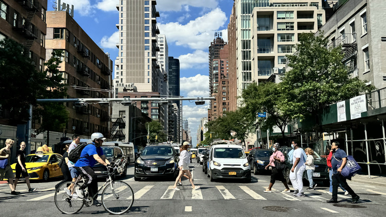 Pedestrians and cyclists cross street in New York City