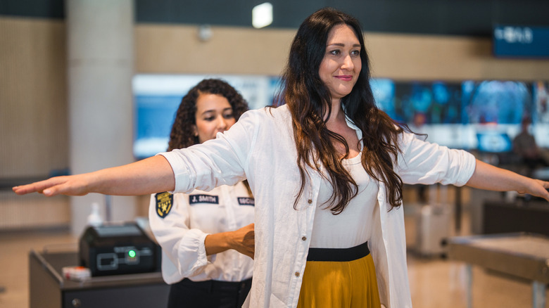 A woman being scanned at airport security