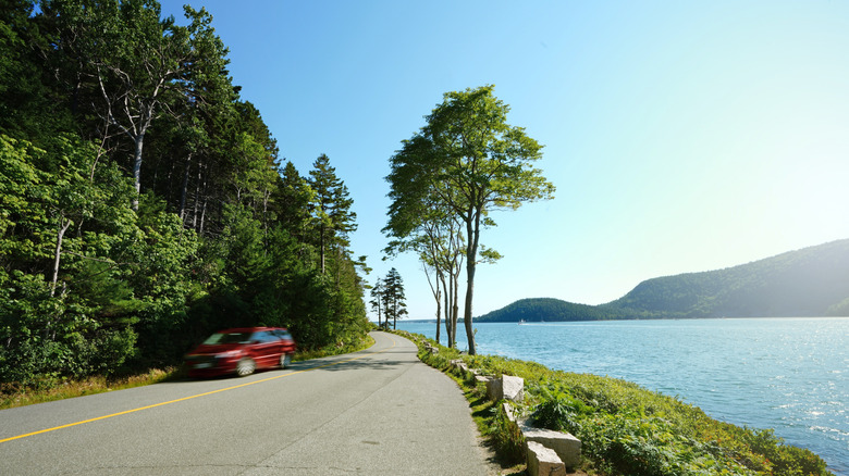 Car driving a coastal road in Acadia National Park, Maine