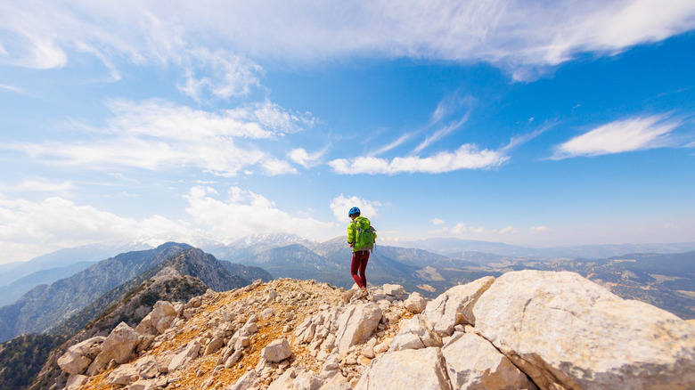 A hiker walks along a mountain ridge