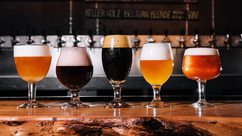 An assortment of beer sit on a counter