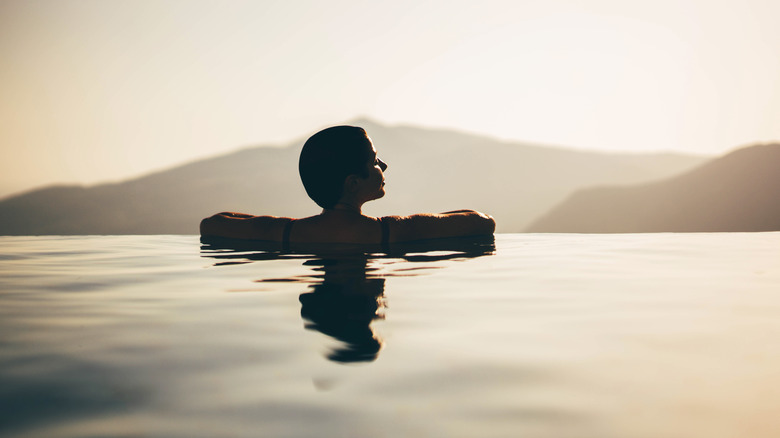 An infinity pool with mountains in the background.