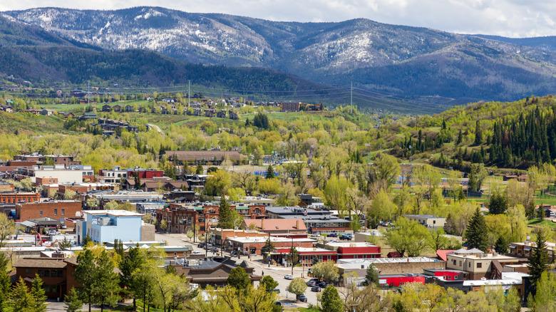 Town of Steamboat Springs, Colorado, nestled in trees with mountains in background