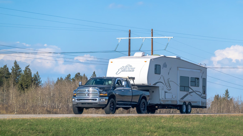 A truck towing a fifth wheel RV