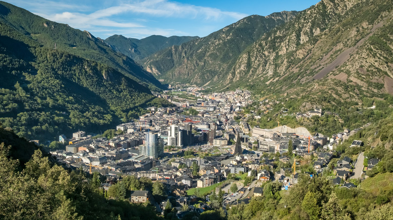 Aerial view of Andorra la Vella, Andorra's capital city surrounded by mountains and forested slopes