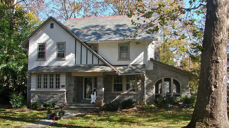 A beautiful rustic home with grassy lawn and leafy trees in Narberth PA.