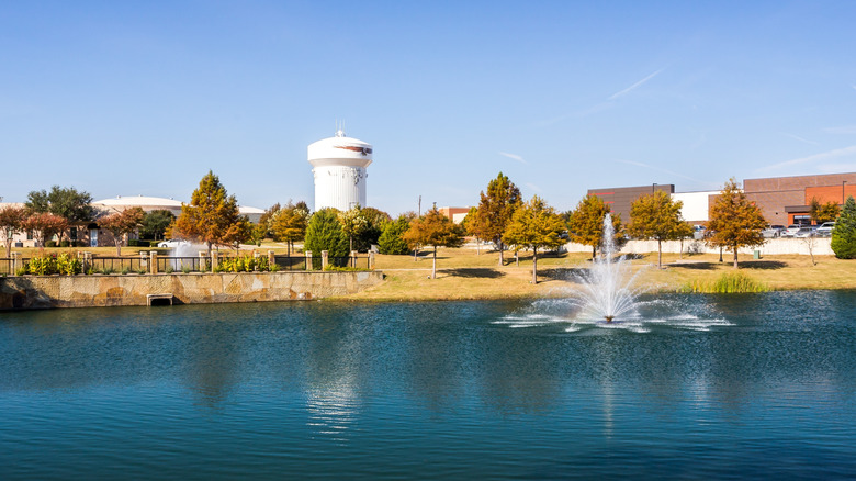 Park with lake and fountain feature in Allen, Texas.
