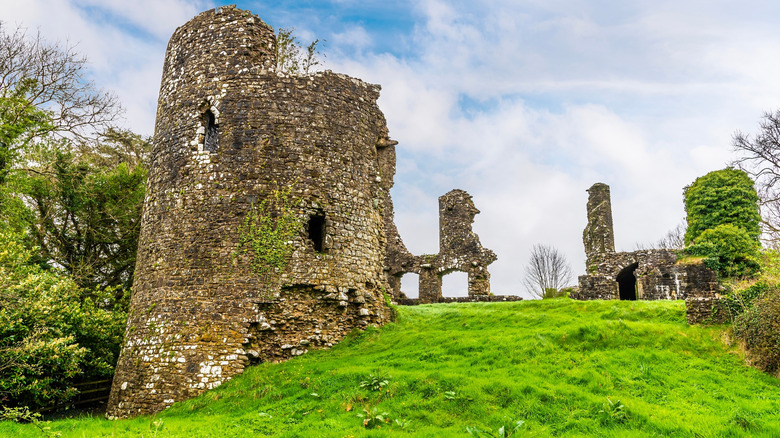 The ruins of Narberth Castle crown a grassy hill on a bright spring day in Wales