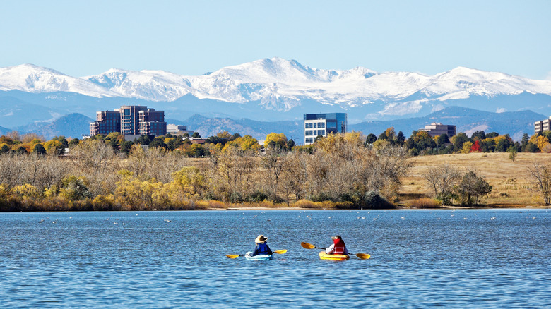 Kayakers on water with mountains in the distance