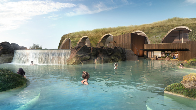 people in thermal pool with waterfall and swim-up bar