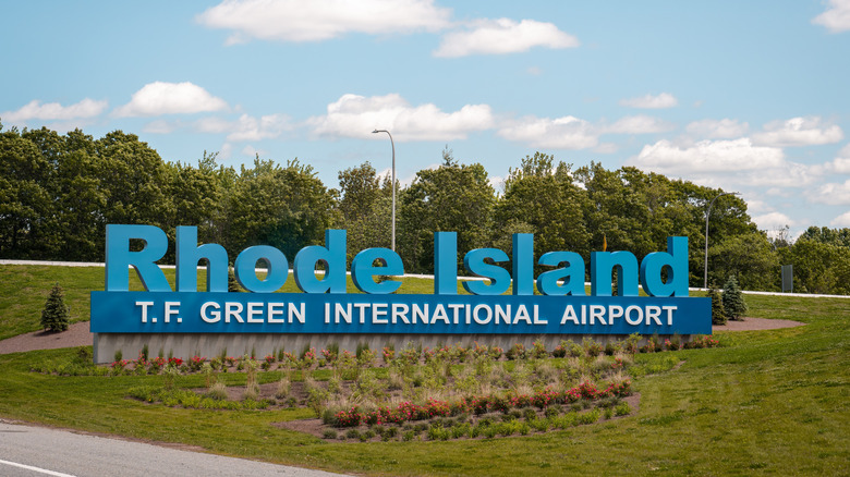 A highway sign indicates the exit for T.F. Green International Airport, Rhode Island