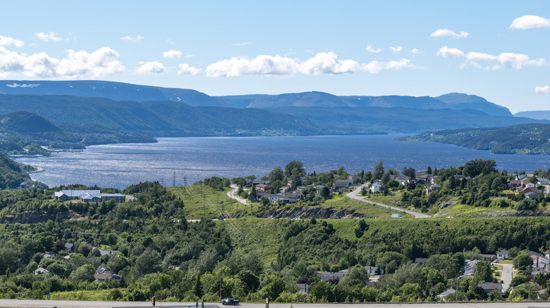 A view of Corner Brook from the highway with the bay and mountains in the background