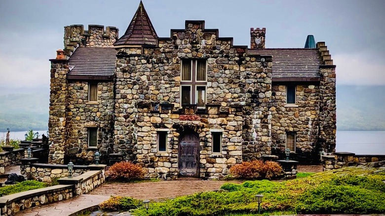 Exterior view of New York's Highlands Castle with Lake George in background
