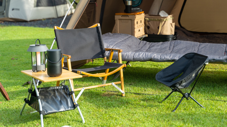 Camping chairs set up outside of a tent
