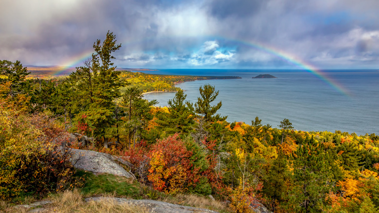 A view of fall foliage, a rainbow, and Lake Superior from Sugarloaf Mountain