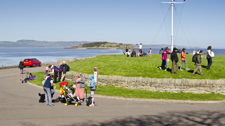 people enjoy the sunshine in Cramond, Scotland.