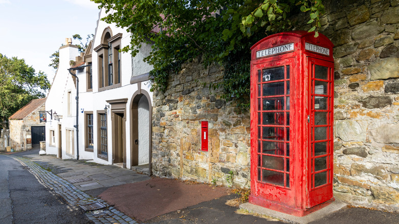 A classic red British phone box near Cramond Island, standing as an symbol of UK heritage by the sea, blending tradition, nostalgia, and the charm of coastal scenery
