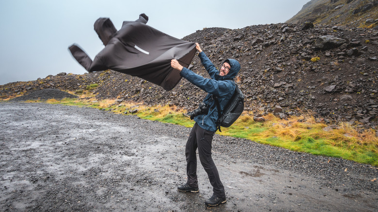 Man holding jacket in Icelandic wind