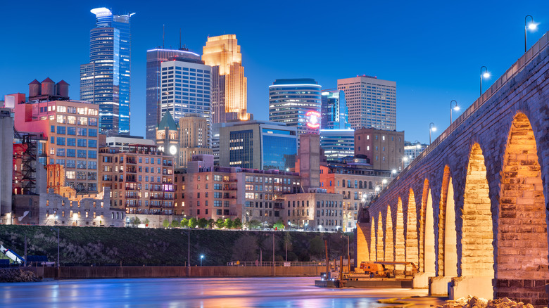 Downtown Minneapolis buildings and bridge at night
