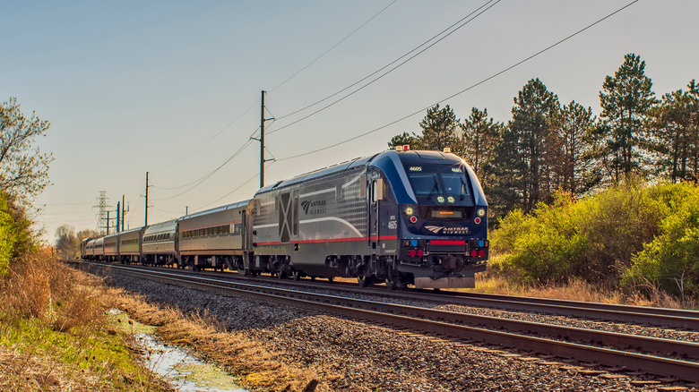 An Amtrak train passes through a Midwest landscape