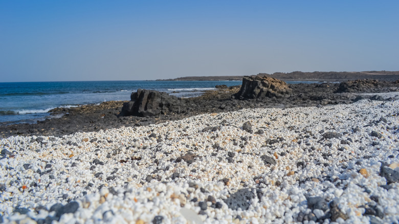 A shot from ground level reveals that the sand on Popcorn Beach looks like white and yellow popcorn kernels