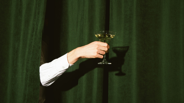 Hand holding a martini glass