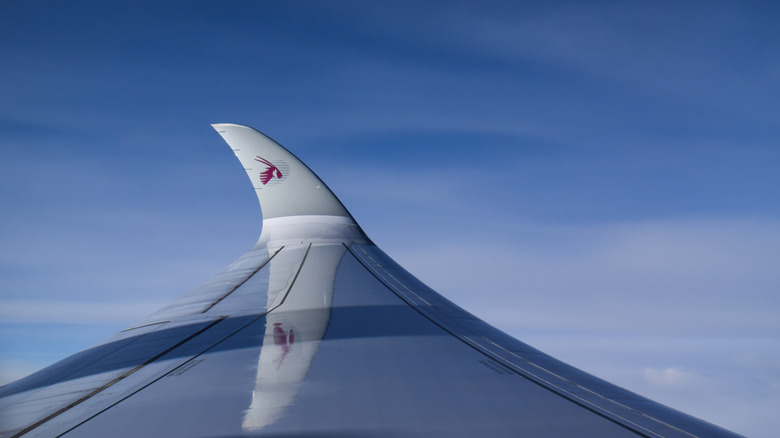 Qatar Airways plane wing with their oryx logo