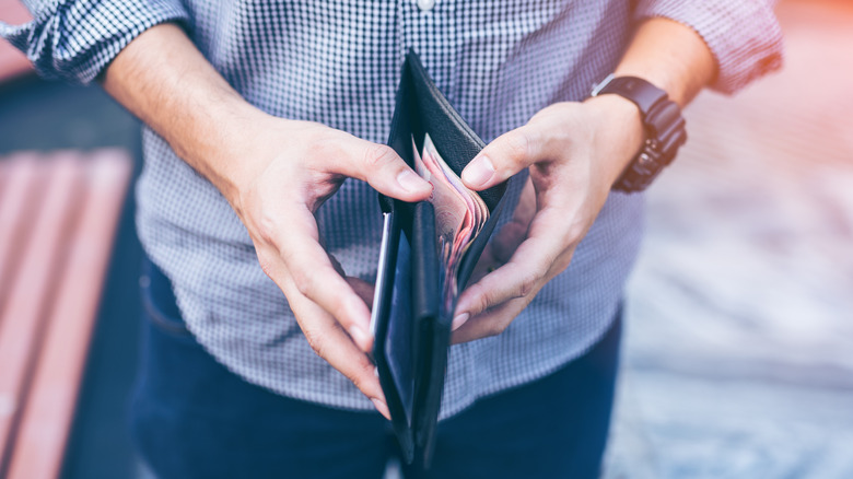 Someone opening a wallet