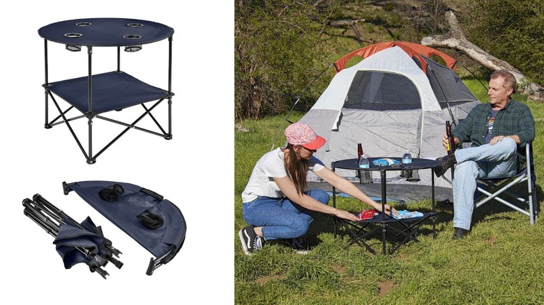 Two campers relax around a folding camping table with a tent outdoors.