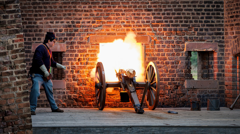 Costumed man performs a cannon demonstration at Old Fort Jackson in Savannah, Georgia