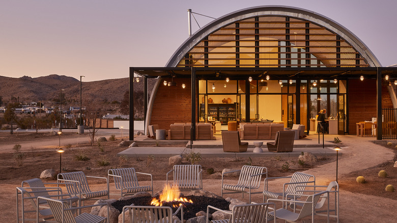 Exterior of The Clubhouse space and outdoor fire pit at AutoCamp Joshua Tree, located in the town of Joshua Tree, California