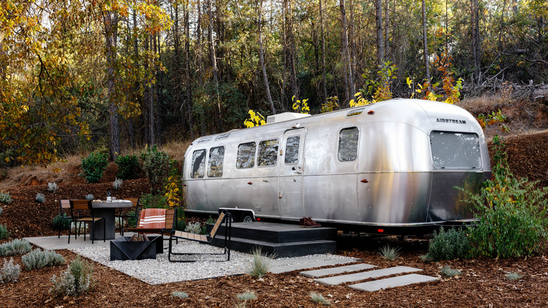 Vintage Airstream, private outdoor dining area, and fire pit at AutoCamp's Yosemite National Park location in California