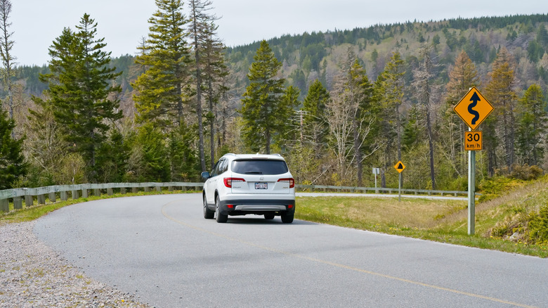 A car drives along the Fundy Trail Parkway in New Brunswick, Canada