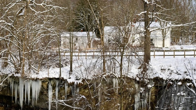 The Inn at Brandywine Falls seen through snowy tree branches in Ohio