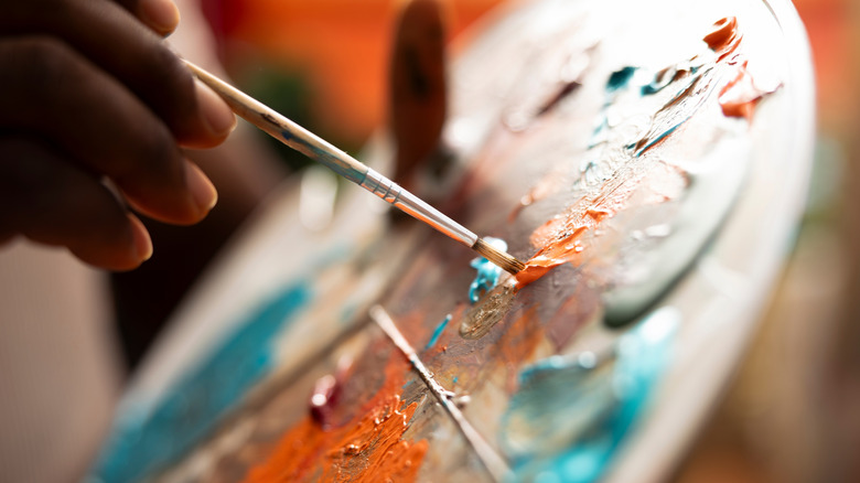 Painter mixing colors on a palette