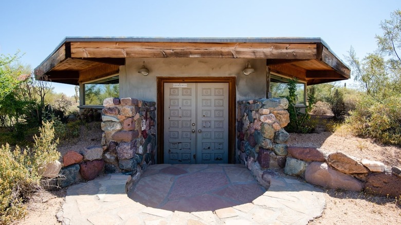 Half-underground stone wooden octagon house with front door closed