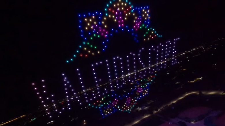 Drones forming Kaleidoscope logo at night