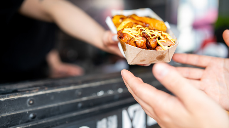 Hands passing food to customer