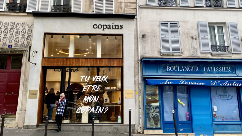 Person standing outside a bakery in Paris