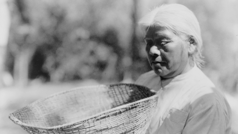 Miwok woman holding a basket