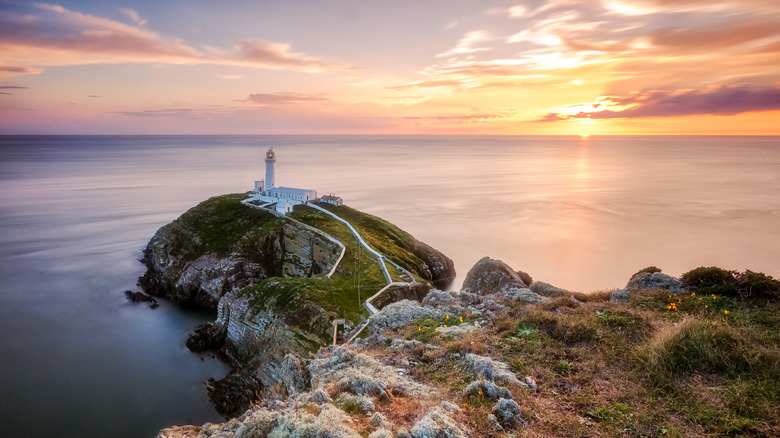 The dramatic, white South Stack Lighthouse at the end of a peninsula